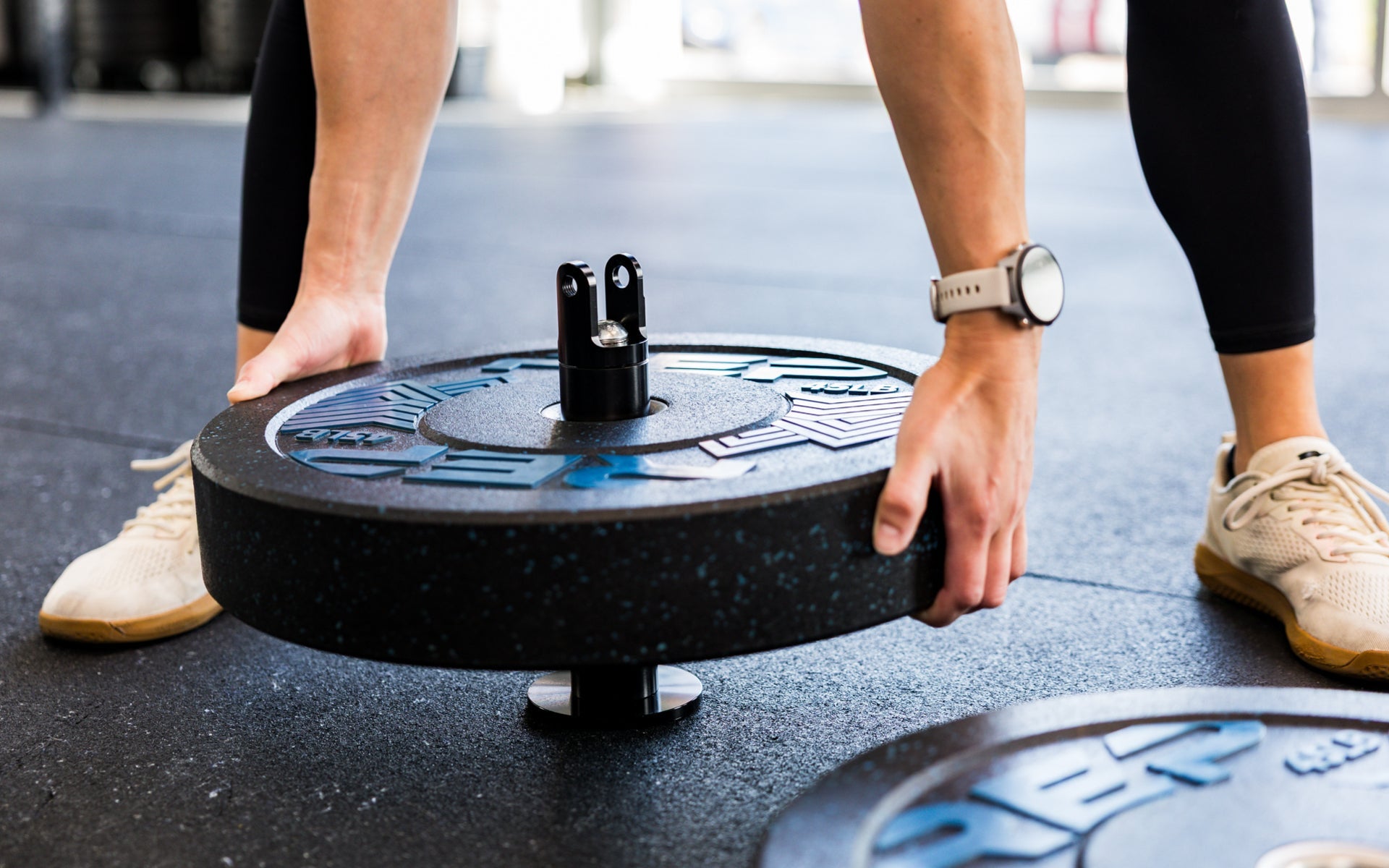An athlete loading plates onto the Free Standing REP® x Kleva Built® Adroit Landmine